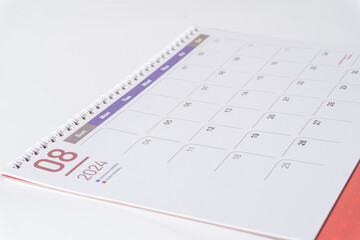 side view of a clean paper calendar on white background. August page of 2024 desk calendar.  