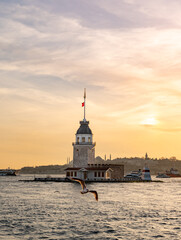 Fototapeta premium Beautiful sunset over Bosphorus with famous Maiden's Tower (Kiz Kulesi) also known as Leander's Tower, symbol of Istanbul, Turkey. Scenic travel background.
