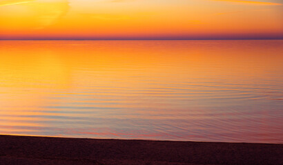 A beautiful minimalist scenery of a sunset at the Baltic sea. Colorful beach landscape of Northern Europe. - 771374608