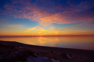 A beautiful minimalist scenery of a sunset at the Baltic sea. Colorful beach landscape of Northern Europe. - 771374609