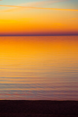 A beautiful minimalist scenery of a sunset at the Baltic sea. Colorful beach landscape of Northern Europe. - 771374618
