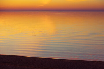 A beautiful minimalist scenery of a sunset at the Baltic sea. Colorful beach landscape of Northern Europe. - 771374619