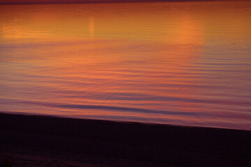 A beautiful minimalist scenery of a sunset at the Baltic sea. Colorful beach landscape of Northern Europe. - 771374637