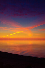 A beautiful minimalist scenery of a sunset at the Baltic sea. Colorful beach landscape of Northern Europe. - 771374641