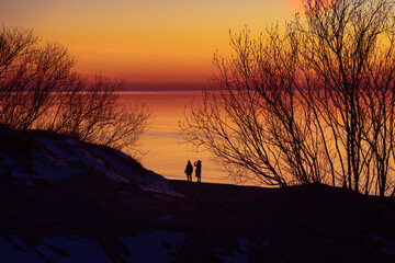 A beautiful spring sunset over the Baltic Sea with colorful skies and calm water. Natural evening scenery of Northern Europe - 771383010