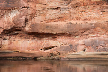 A beautiful sandstone cliffs at the river in Gauja National Park, Latvia. Springtime landscape of Northern Europe. - 771395209