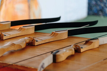 wooden bows lie on stand