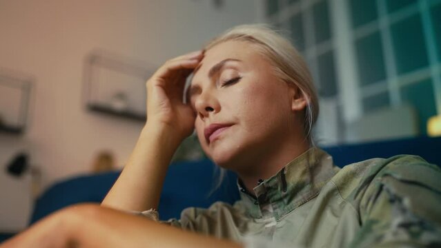 Stressed female soldier suffering from posttraumatic stress disorder, trauma