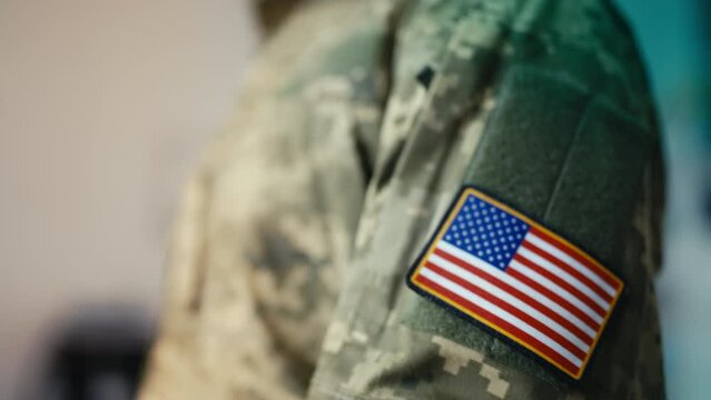 Woman soldier putting on U.S. military patch, getting ready to leave for work