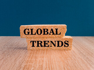 Global trends symbol. Concept words GLOBAL TRENDS on brick blocks. Beautiful blue background,...