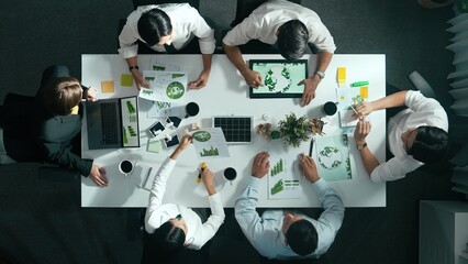Top down view of business team discussing about using clean energy and sustainable investment at...