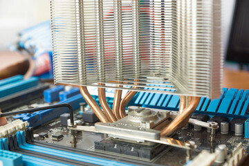 Close-Up View of a Computer Motherboard With Copper Heat Sink and Circuits