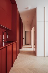 Hallway with red cabinets, a sink, and brown hardwood flooring