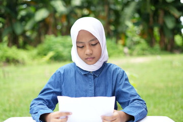 Portrait of an Asian girl wearing a white hijab