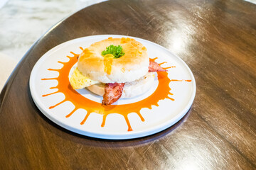 Fresh healthy bagel with egg and bacon for breakfast.