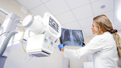 The doctor analyzes the condition of the lungs. Doctor with x-ray of lungs in hands in modern...