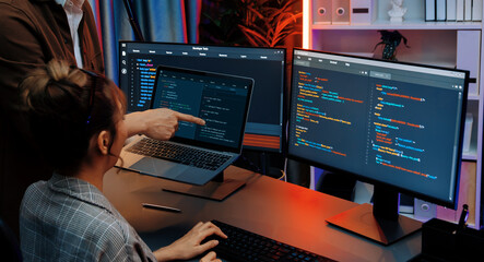 Serious of IT developers discussing intelligent website development coder system running data...