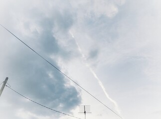 An old TV antenna and electric pole under the sky background 