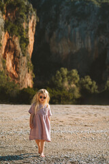 Child girl walking on the beach outdoor family travel lifestyle summer vacations in Albania kid 4 years old enjoying nature Gjipe canyon - 771420436