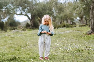 Child girl walking in olive groves  outdoor family travel lifestyle summer vacations kid 4 years old enjoying nature