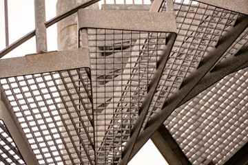 details of a metal spiral staircase in an industrial building