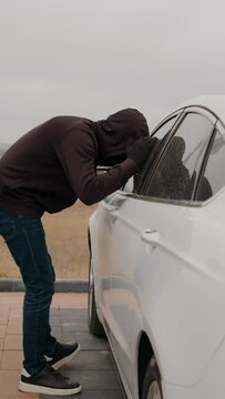 Vertical video of criminal car thief steals car. Act of stealing car requires skill and precision Stolen car becomes another statistic in city's rising crime rate heightened vigilance citizens.