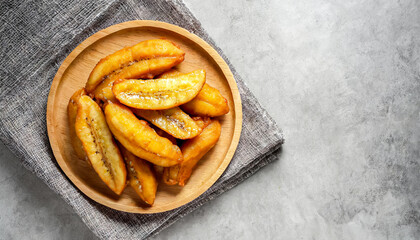 thai street food. top view shot of fried bananas on concrete table. thai style, copy space .