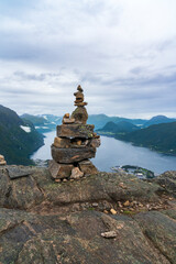 A cairn stack of stones and view from hiking Rampestreken and Nesaksla in Andalsnes - 771449607
