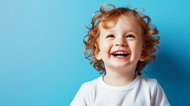 happy boy, smiling fce, light blue background.