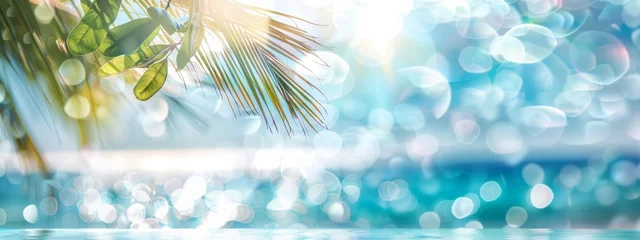 Rolgordijnen Abstract blur defocused background, toned gently blue, nature of tropical summer, rays of sun light. Beautiful sun glare on sea water and palm leaves against sky. Copy space, summer vacation concept. © JovialFox