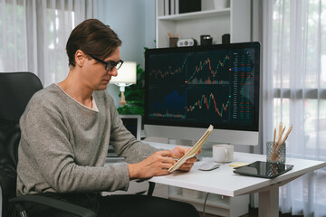 Smart businessman trader in casual day analyzing with profit value of dynamic increased stock...