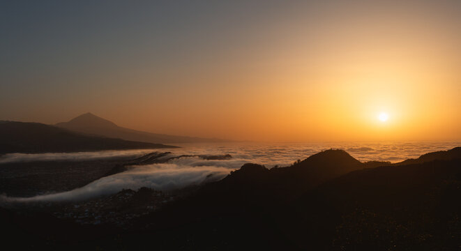 Beautiful sunset scenery with clouds over the ocean and volcano Teide. Tenerife, Spain.