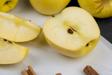 yellow ripe apple with cinnamon on the table