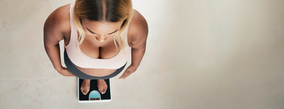 Health Goals: Woman Checking Weight on a Digital Scale. Personal health monitoring.
