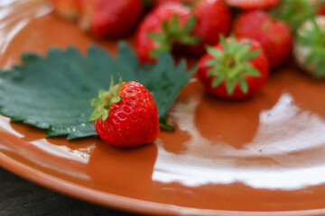 selective focus bright red strawberries on a ceramic plate, looks delicious, lots of strawberries in the plate Eat for health