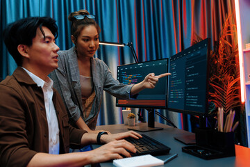 IT developers discussing with point to intelligent website development coder system running data...