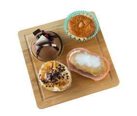 Group of small cakes of different flavors and sizes on isolated background.