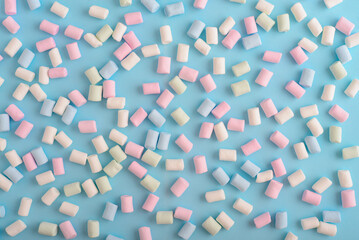 Colorful marshmallows pattern on blue background. - 771491663