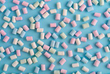 Colorful marshmallows pattern on blue background. - 771491683