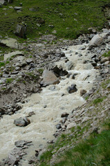 a mountain river flowing down a mountain gorge.a stormy water flow.