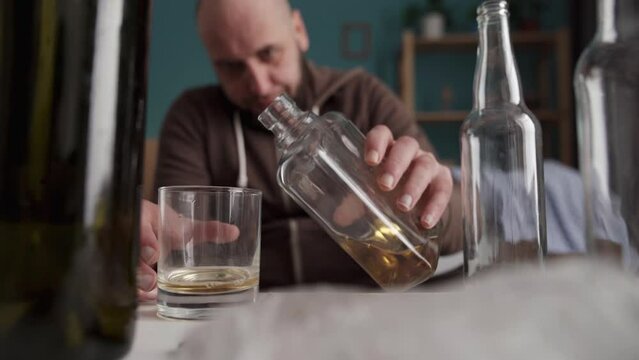 drunk man alcoholic drinking whiskey at home. Loneliness and stress. alcoholism, alcohol addiction