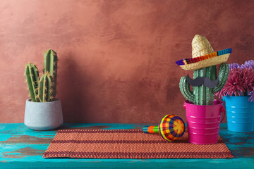 Empty wooden table with place mat  and cactus decoration over wall  background. Mexican party mock up for design and product display - 771498670