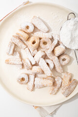 Top view of shortbread cookies in powdered sugar  on white plate - 771499402