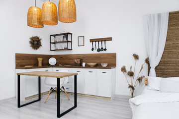 Close up contemporary kitchen with island, supplies equipment, table top, spice jars with kitchenware. Set of utensils standing on shell. Modern interior, different devices
