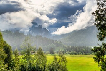 Scenic view of a lush verdant valley from the Bernina Express in Switzerland.