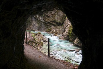 View of a river in the Partnach Gorge, seen from a cave. Germany.