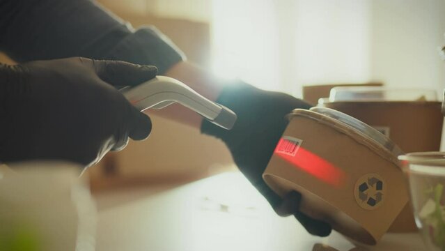 Full-time warehouse employees scan barcodes using laser scanners, demonstrating an example of the effective use of modern technologies in the field of logistics and inventory management