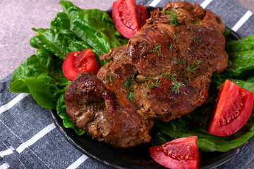 Roasted pork neck served with vegetables. Hot meat meal with spices