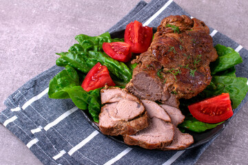 Roasted pork neck served with vegetables and cut into slices. Hot meat meal with spices - 771508035