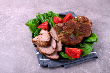 Roasted pork neck served with vegetables and cut into slices. Hot meat meal with spices - 771508036